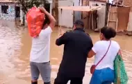 Lambayeque: Polica ayuda a cruzar a seora en el distrito de Illimo inundado tras desborde de ro La Leche