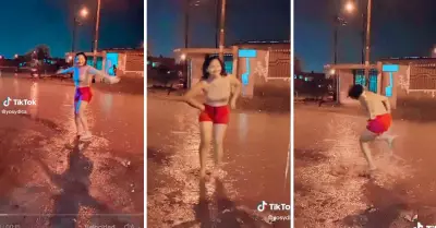 Mujer zapatea bajo la lluvia al ritmo de huayno.