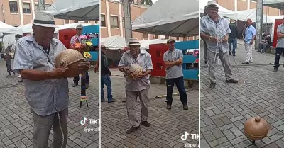 Adulto mayor recibe ovacin al hacer bailar un gran trompo en la calle.
