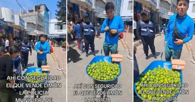 Vendedor ofrece limones acompaado de "seguridad".