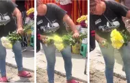 Ingenio o estafa? Captan a mujer pintando flores para volverlas amarillas en plena va pblica
