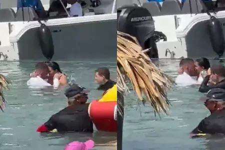 Pareja tiene intimidad en una playa repleta de turistas.