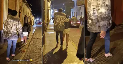 Joven prest sus zapatillas a su pareja y l se pone sus tacones.