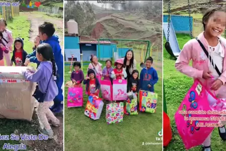 Nios de colegio rural felices al recibir regalos por Navidad.