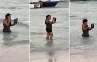 Joven es captada con su laptop dentro del mar y usuarios reaccionan: "De vacaciones, pero responsable"