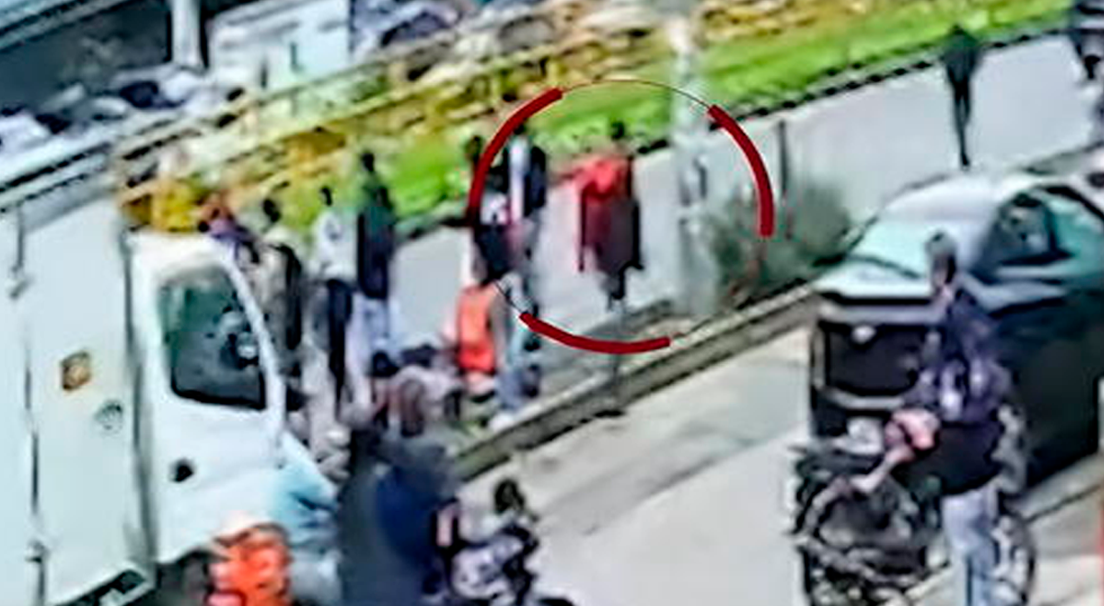 Sujeto coloca la mochila roja sobre su espalda y se va de la escena del accidente.