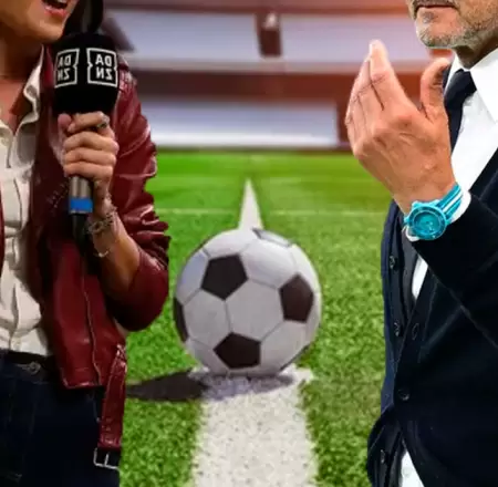 DT de f�tbol besa a reportera en vivo.